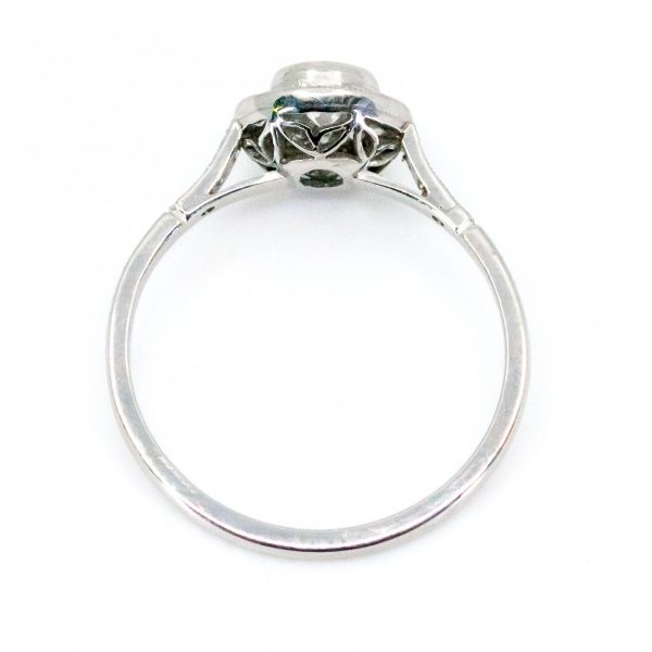 This lovely engagement vintage Art Deco revivalist design ring features a 0.40ct (H SI1) brilliant cut diamond decorated with 0.25ct single cut diamonds crafted in platinum.