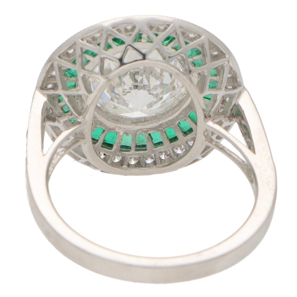 Diamond and emerald double target ring in platinum.