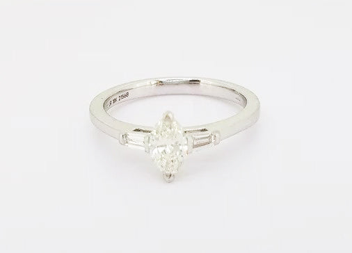 Marquise Cut Diamond Engagement Ring; set with a 0.45ct marquise-cut diamond flanked by 0.13ct baguette-cut diamond set shoulders, 18ct white gold.