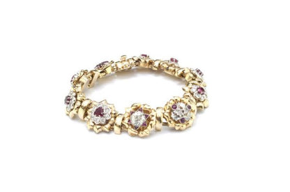 Vintage 7ct Diamond and Ruby Cluster Bracelet; set with 7.00 carats of diamonds and 3.00 carats of rubies in intricate and unique floral clusters surrounded by gold leaves, in 18ct yellow gold, Circa 1930s