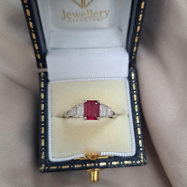 1ct Burma Ruby and Baguette Diamond Engagement Ring, 1.07ct emerald-cut Burmese ruby flanked with graduated stepped baguette-cut diamonds in platinum