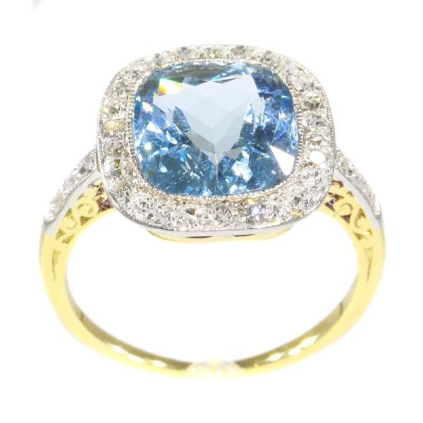 Vintage Aquamarine and Diamond Cluster Ring; central 4.17ct cushion-cut aquamarine surrounded by 0.52cts old-cut diamonds, in platinum and 18ct yellow gold, Circa 1920