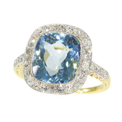 Vintage Aquamarine and Diamond Cluster Ring; central 4.17ct cushion-cut aquamarine surrounded by 0.52cts old-cut diamonds, in platinum and 18ct yellow gold, Circa 1920