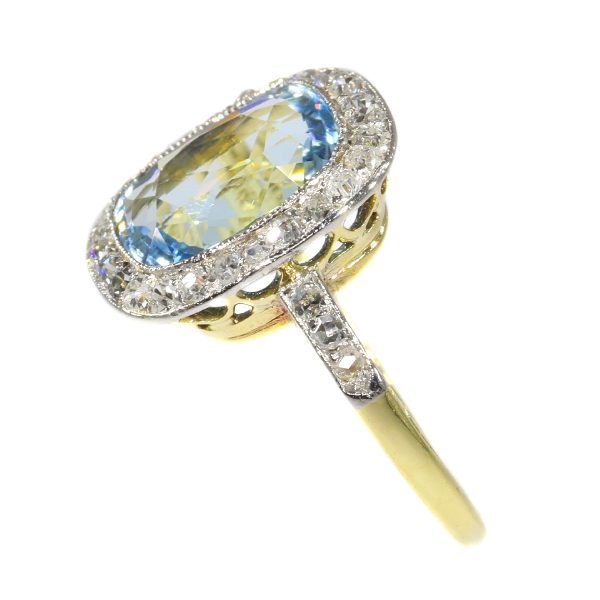 Vintage Aquamarine and Diamond Cluster Ring; central 4.17ct cushion-cut aquamarine surrounded by 0.52cts old-cut diamonds, in platinum and 18ct yellow gold, Circa 1920