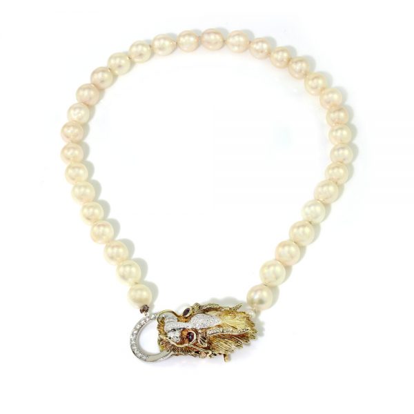 Vintage South Sea Pearl Necklace with Diamond Set Dragons Head Clasp; the striking 14ct yellow gold clasp in the form of a dragon's head is decorated with diamonds and ruby eyes, Circa 1970s