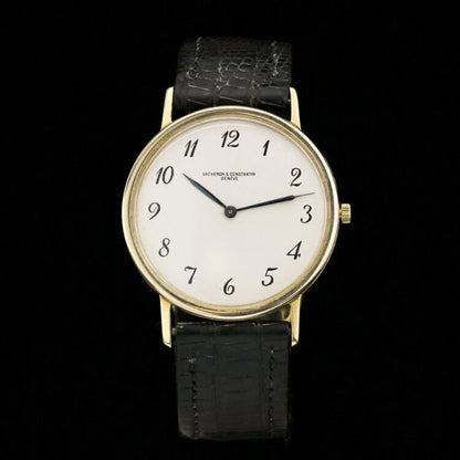 Vintage Vacheron Constantin 18ct Yellow Gold 33mm Manual Watch, white dial with black Arabic numerals, on a black leather strap. Circa 1960s
