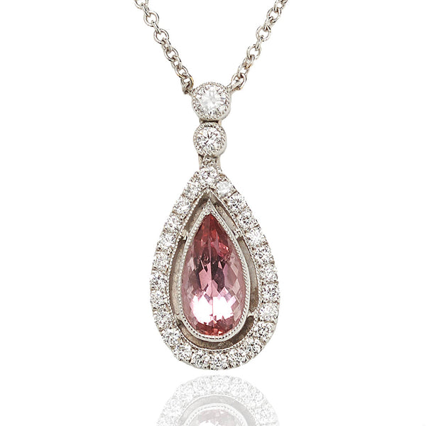 Topaz and diamond cluster drop pendant set in 18 carat white gold.