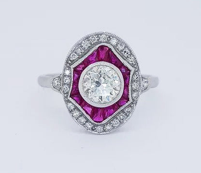 Diamond and Ruby Oval Cluster Dress Ring; 0.89 carat brilliant-cut diamond surrounded by calibre-cut rubies and an outer border of diamonds, 18ct white gold