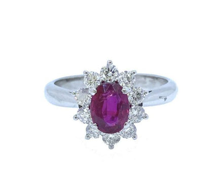 Mozambique Ruby and Diamond Oval Cluster Ring; 1.11 carat oval faceted ruby with no heat treatments surrounded by ten round brilliant-cut diamonds, in 18ct white gold