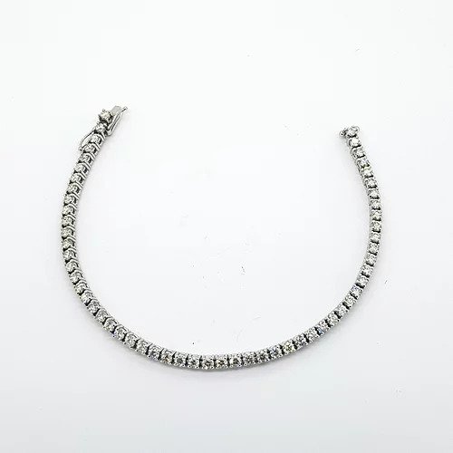 Contemporary diamond line bracelet set with 57 brilliant cut diamonds claw set in 18ct white gold, 5.00 carat total, diamond topped push clasp with two 'D' safety clips