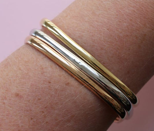 Vintage Tri Colour 18ct Gold Bangle; three heavy 18ct gold rounded square bangles; one yellow, one rose and one white gold, France, 1970's