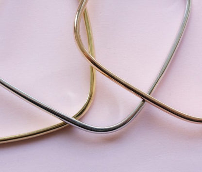 Vintage Tri Colour 18ct Gold Bangle; three heavy 18ct gold rounded square bangles; one yellow, one rose and one white gold, France, 1970's