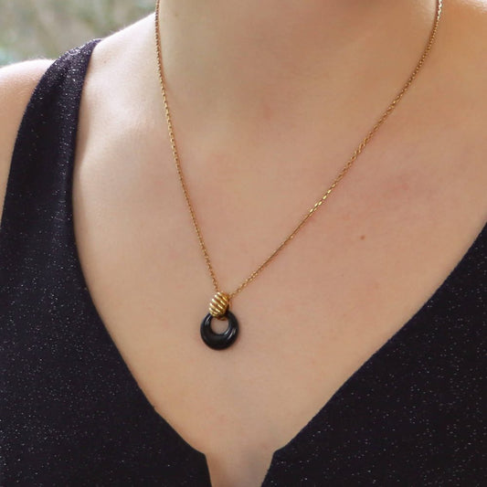 Van Cleef & Arpels onyx disk pendant necklace in gold.