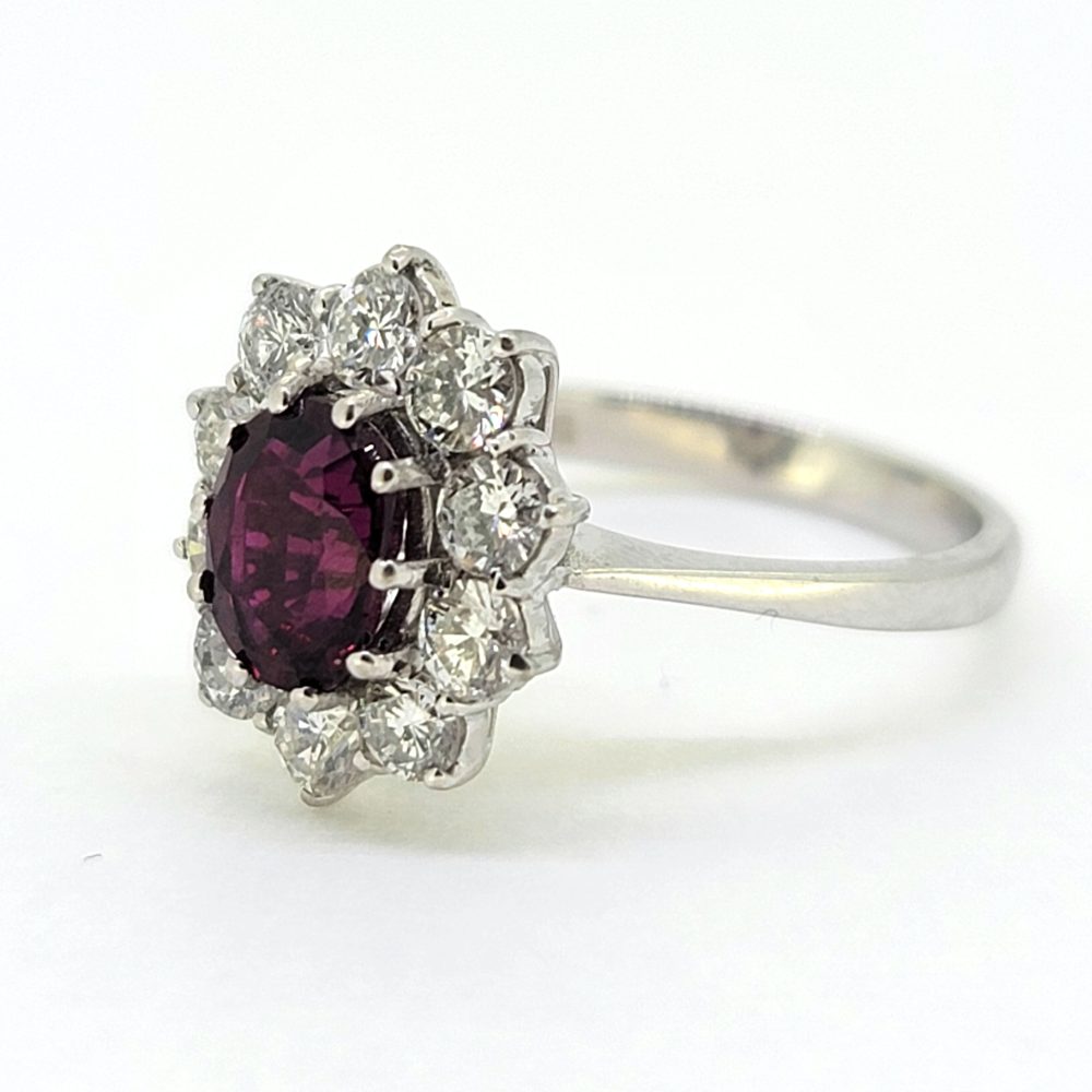 Natural No Heat Ruby and Diamond Cluster Engagement Ring, oval-cut Thai ruby with no indication of heat treatment surrounded by 1ct sparkling round brilliant-cut diamonds in 18ct white gold