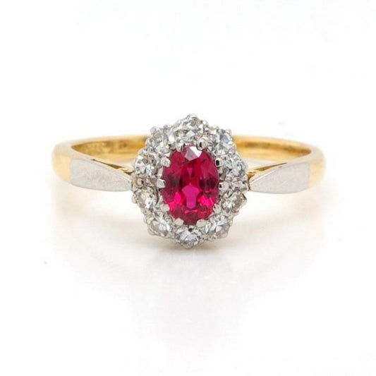 Vintage Red Spinel and Diamond Cluster Ring; oval faceted spinel surrounded by 0.36cts single cut diamonds, in 18ct yellow gold. Circa 1930s