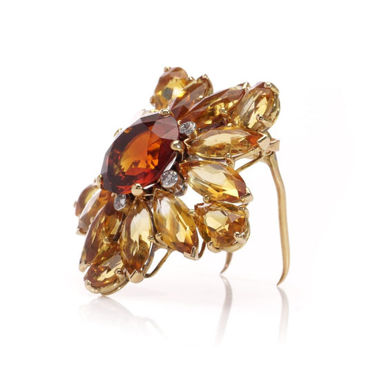 Gold sunflower brooch with garnet, topaz and diamonds.