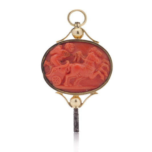 Victorian pocket watch key/pendant in gold and carved coral showing neoclassical scenes.
