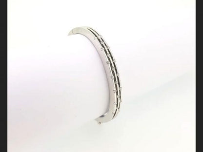 Diamond Bangle; Triple row of interspersed round cut diamonds set into an 18ct white gold bangle. A delicate and chic piece of jewellery