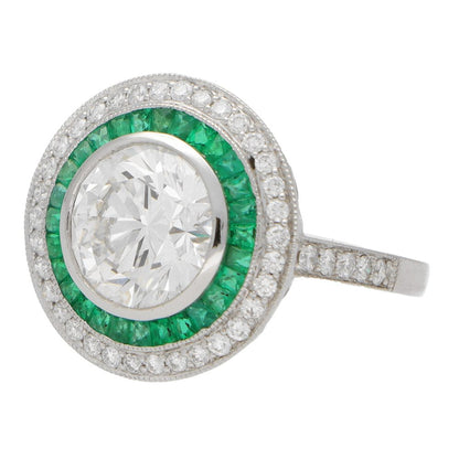Diamond and emerald double target ring in platinum.