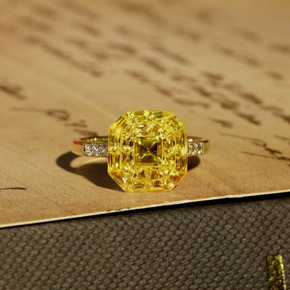 Yellow Sapphire Octagonal Cluster Solitaire Engagement Ring, 5.27cts yellow sapphires arranged in an invisible setting to produce an octagonal shaped design in 14ct yellow gold with diamond set shoulders