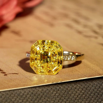 Yellow Sapphire Octagonal Cluster Solitaire Engagement Ring, 5.27cts yellow sapphires arranged in an invisible setting to produce an octagonal shaped design in 14ct yellow gold with diamond set shoulders