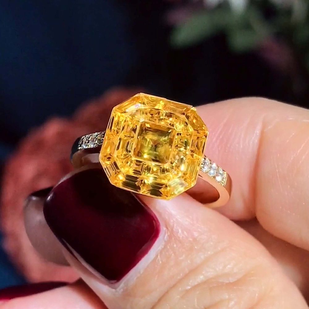 Yellow Sapphire Octagonal Cluster Solitaire Engagement Ring, 5.27cts yellow sapphires arranged in an invisible setting to produce an octagonal shaped design in 14ct yellow gold with diamond set shoulders