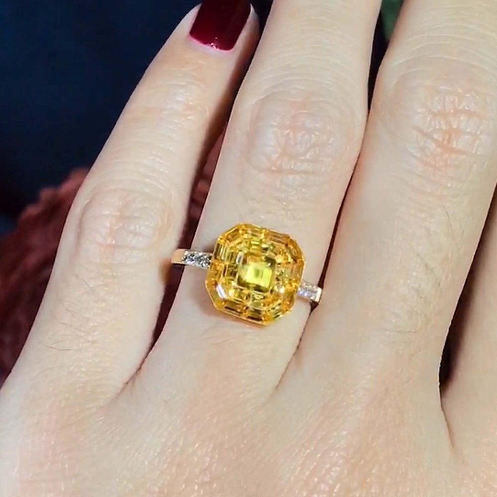 Yellow Sapphire Octagonal Cluster Solitaire Engagement Ring, 5.27cts yellow sapphires arranged in an invisible setting to produce an octagonal shaped design in 14ct yellow gold with diamond set shoulders