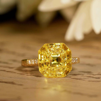Yellow Sapphire Octagonal Cluster Solitaire Engagement Ring, 5.27cts yellow sapphires arranged in an invisible setting to produce an octagonal shaped design in 14ct yellow gold with diamond set shoulders