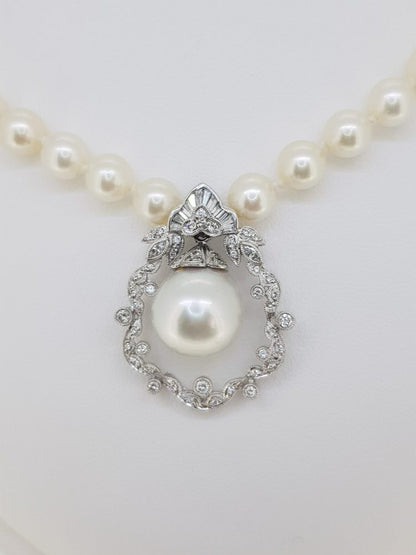 South Sea Pearl and Diamond Pendant Necklace; pendant features a South Sea pearl within a diamond-set floral surround, suspended from cultured pearl strung necklace