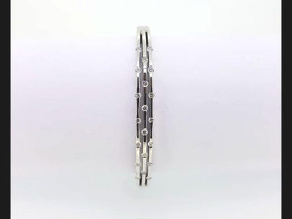 Diamond Bangle; Triple row of interspersed round cut diamonds set into an 18ct white gold bangle.