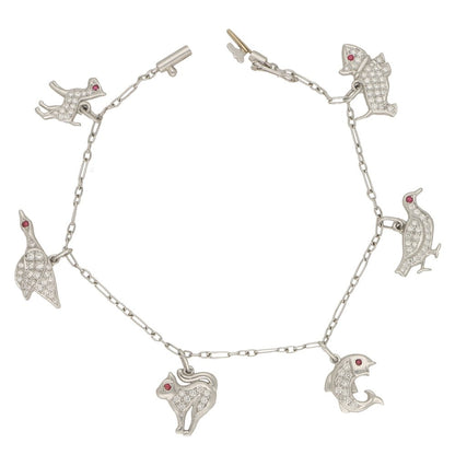 Vintage 1950s Animal Platinum Charm Bracelet with Diamonds and Rubies; six diamond-set charms with a ruby eye; a dog, grouse, fish, cat, duck and foul, 1.03 carats